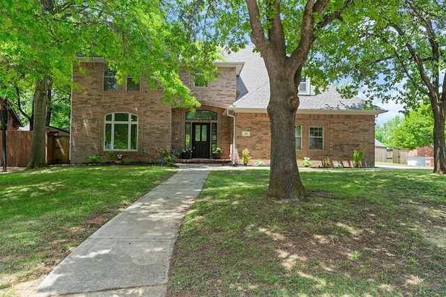 traditional-style home featuring brick siding and french doors