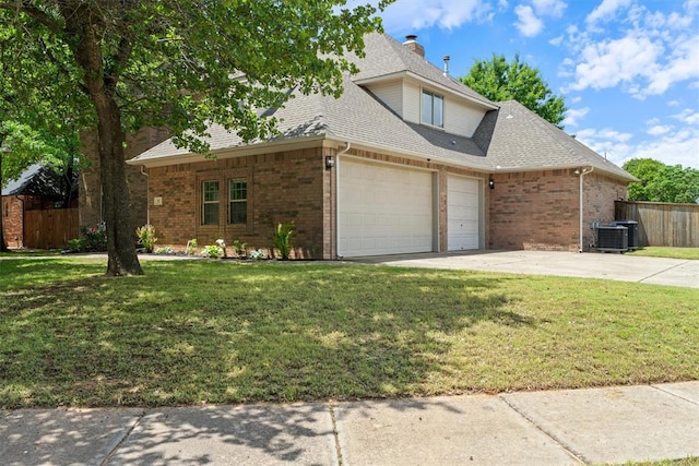 traditional-style home featuring brick siding, an attached garage, central AC, and roof with shingles