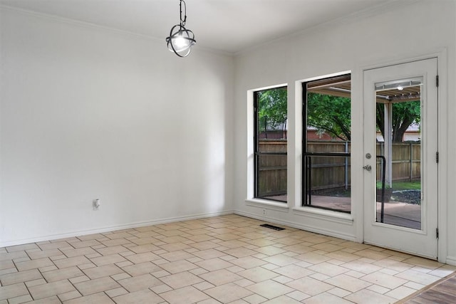 spare room featuring healthy amount of natural light, crown molding, and baseboards