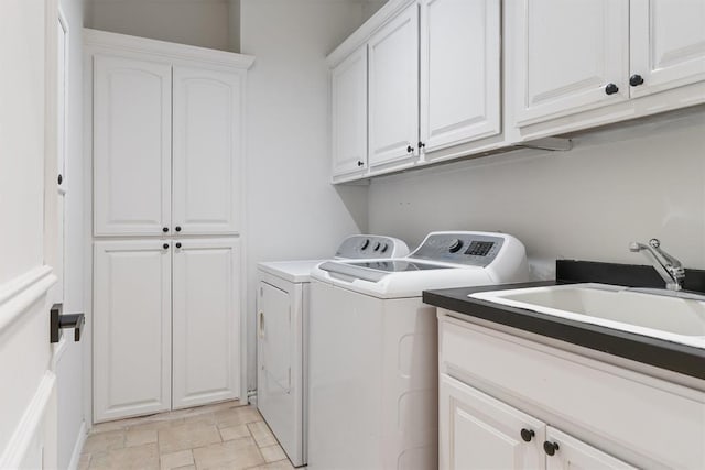 laundry area featuring washer and dryer, cabinet space, and stone finish flooring