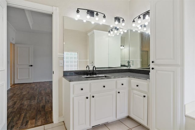 bathroom with crown molding, vanity, and wood finished floors