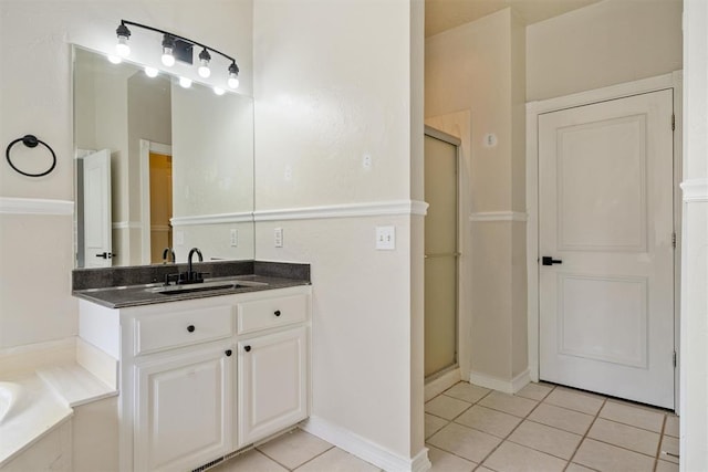 bathroom featuring tile patterned flooring, a stall shower, vanity, and a bath