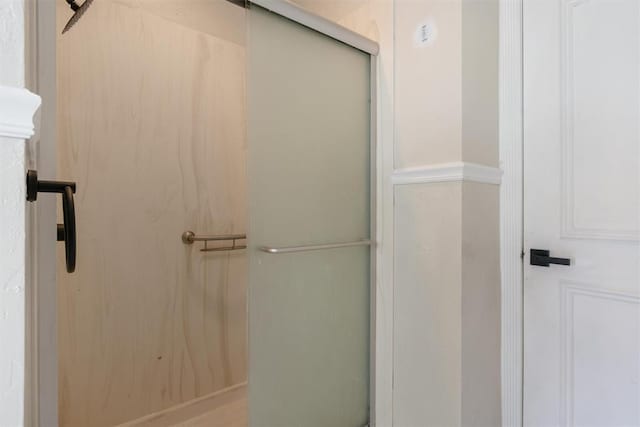 full bath featuring a shower with door