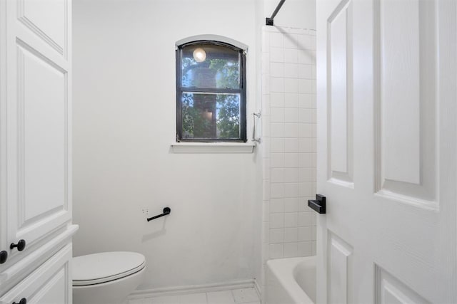 bathroom with toilet, baseboards, and bathing tub / shower combination