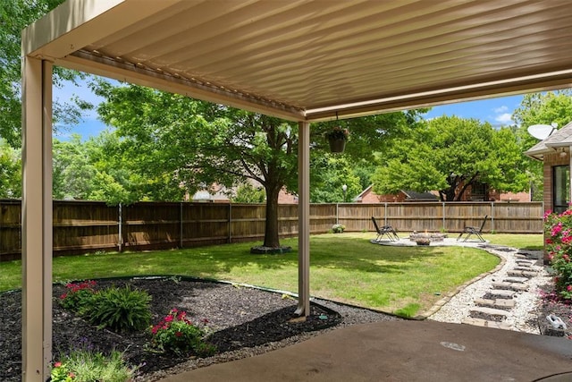 view of yard featuring an outdoor fire pit and a patio area