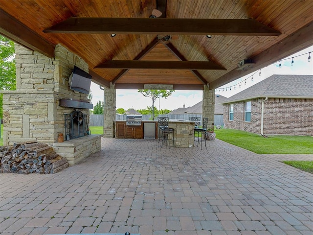 view of patio / terrace featuring area for grilling, a gazebo, exterior bar, and grilling area