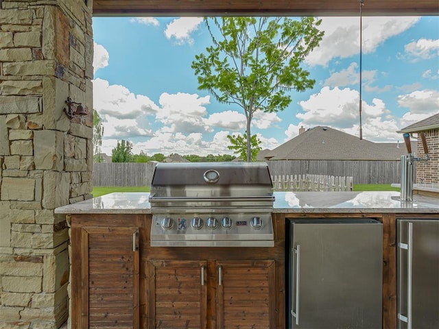 view of patio with grilling area, area for grilling, and a fenced backyard