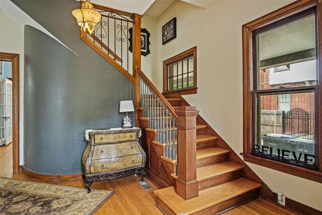 3715 N Mckinley Ave, Oklahoma City, OK 73118 - stairway with wood finished floors and a chandelier