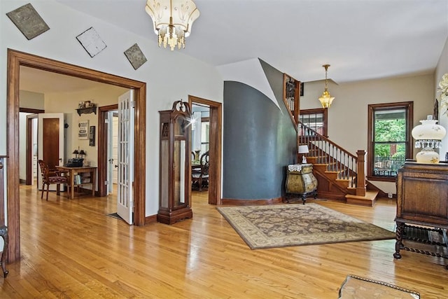 3715 N Mckinley Ave, Oklahoma City, OK 73118 - entrance foyer featuring light wood finished floors, stairs, and a chandelier