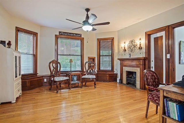 3715 N Mckinley Ave, Oklahoma City, OK 73118 - living area with light wood finished floors, ceiling fan, healthy amount of natural light, and a fireplace with flush hearth