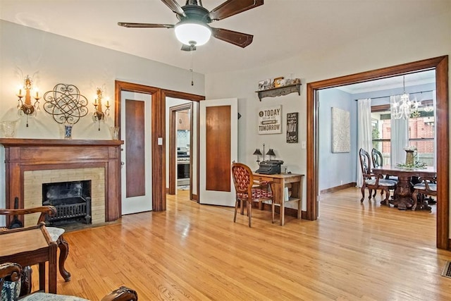 3715 N Mckinley Ave, Oklahoma City, OK 73118 - living area with a chandelier, light wood finished floors, a ceiling fan, a fireplace with flush hearth, and baseboards