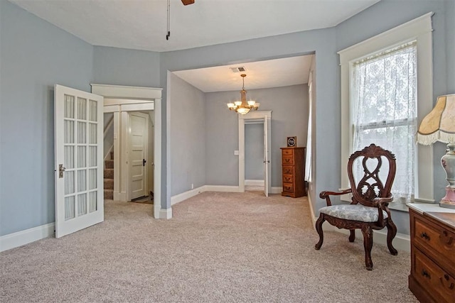 3715 N Mckinley Ave, Oklahoma City, OK 73118 - living area featuring light carpet, a chandelier, baseboards, and a ceiling fan