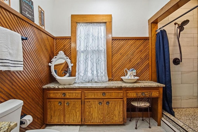 3715 N Mckinley Ave, Oklahoma City, OK 73118 - bathroom featuring toilet, a stall shower, a wainscoted wall, vanity, and wood walls