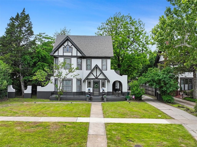3715 N Mckinley Ave, Oklahoma City, OK 73118 - english style home featuring stucco siding, a shingled roof, and a porch