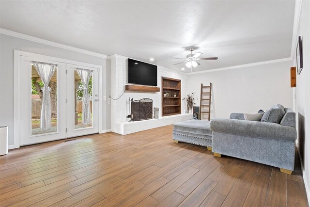 8309 NW 101st St, Oklahoma City, OK 73162 - living room with a fireplace, ceiling fan, wood finished floors, ornamental molding, and baseboards
