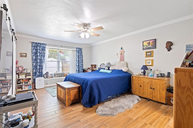 8309 NW 101st St, Oklahoma City, OK 73162 - bedroom with a barn door, light wood finished floors, crown molding, and ceiling fan