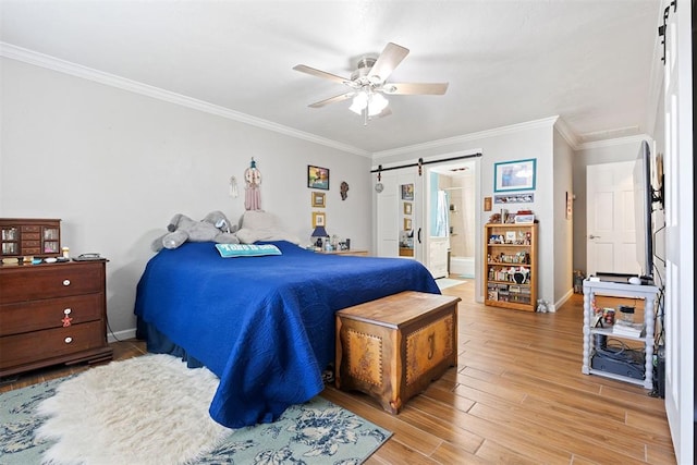 8309 NW 101st St, Oklahoma City, OK 73162 - bedroom with a barn door, crown molding, light wood-style flooring, baseboards, and ceiling fan