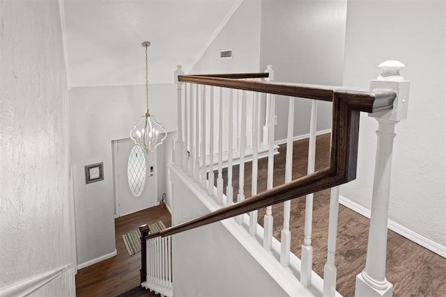 8309 NW 101st St, Oklahoma City, OK 73162 - stairs featuring wood finished floors and a chandelier
