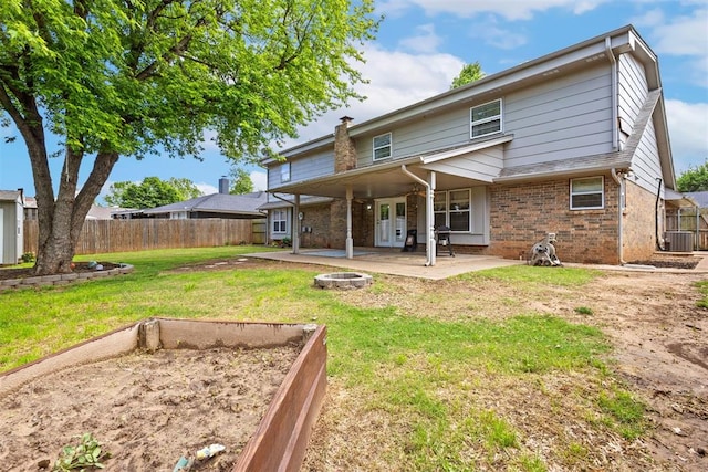 8309 NW 101st St, Oklahoma City, OK 73162 - back of house featuring a patio area, brick siding, central AC, and a fire pit