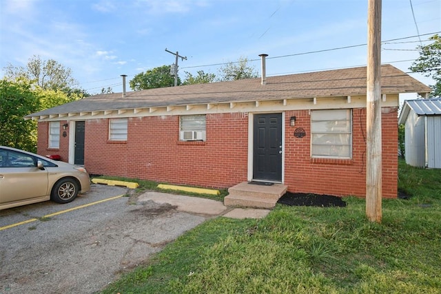 2819 SW 33rd St, Oklahoma City, OK 73119 - view of front facade with uncovered parking, brick siding, and roof with shingles