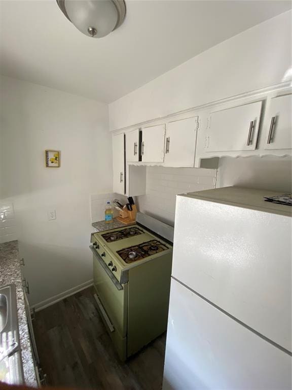 2819 SW 33rd St, Oklahoma City, OK 73119 - kitchen featuring white appliances, dark wood-style floors, white cabinetry, and baseboards