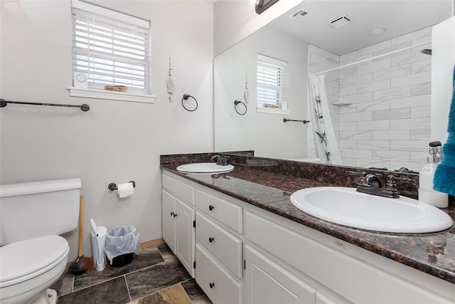 416 S Harrison Ave, Blanchard, OK 73010 - bathroom featuring toilet, double vanity, a shower with shower curtain, and baseboards