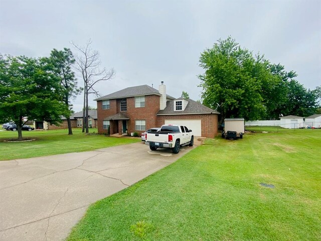416 S Harrison Ave, Blanchard, OK 73010 - view of front of property featuring brick siding, driveway, a front yard, a garage, and a chimney