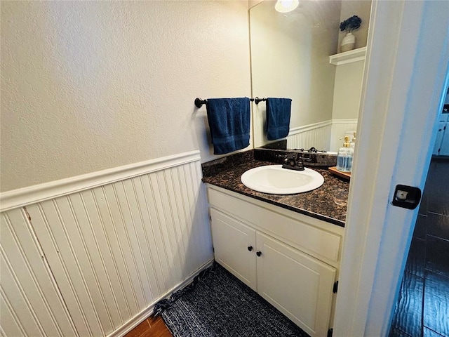 416 S Harrison Ave, Blanchard, OK 73010 - bathroom with vanity, wainscoting, and a textured wall
