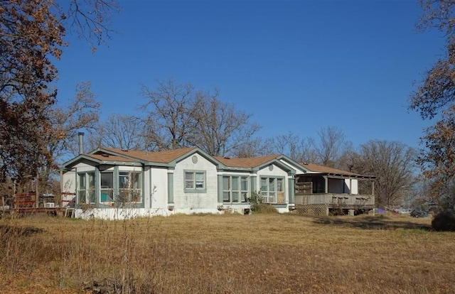 17551 Banner Rd, Lexington, OK 73051 - back of property with a sunroom, a deck, and a lawn