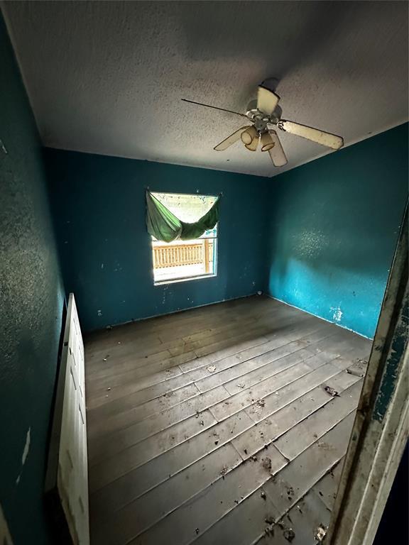 17551 Banner Rd, Lexington, OK 73051 - spare room featuring hardwood / wood-style flooring, a textured ceiling, and ceiling fan