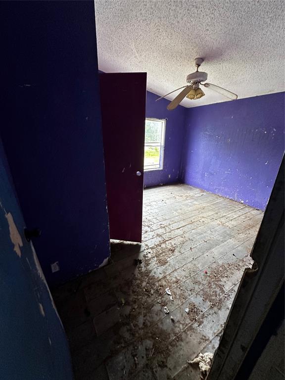 17551 Banner Rd, Lexington, OK 73051 - empty room with a textured ceiling and ceiling fan
