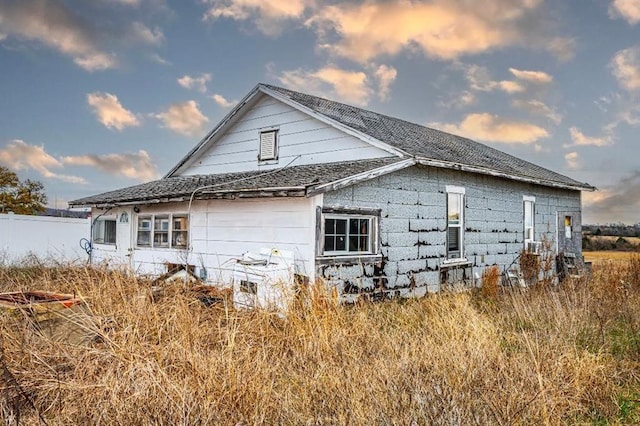 10015 S Bryant Rd, Henryetta, OK 74437 - view of property exterior featuring roof with shingles and fence
