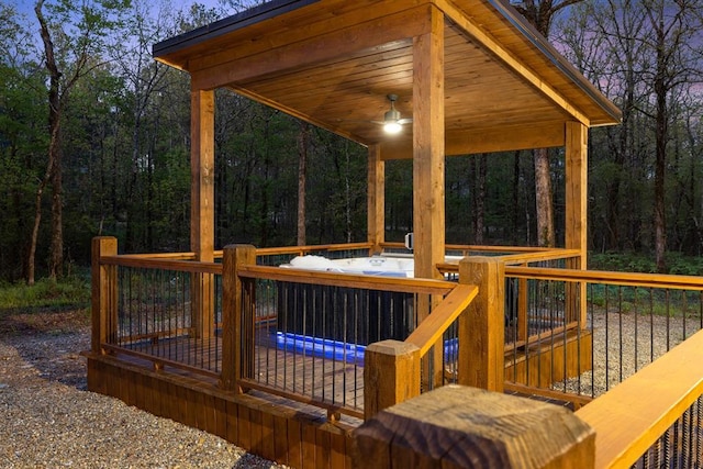wooden terrace featuring a forest view