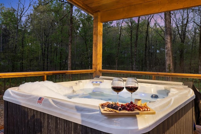 wooden deck featuring a hot tub
