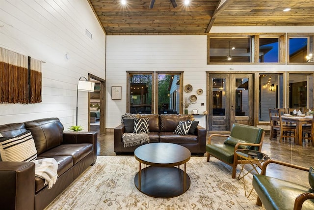 lobby featuring wooden ceiling, wooden walls, and a high ceiling