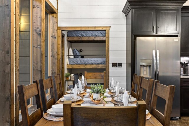 dining room featuring wooden walls