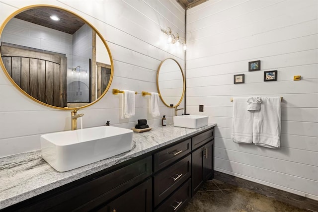 full bath with double vanity and wooden walls