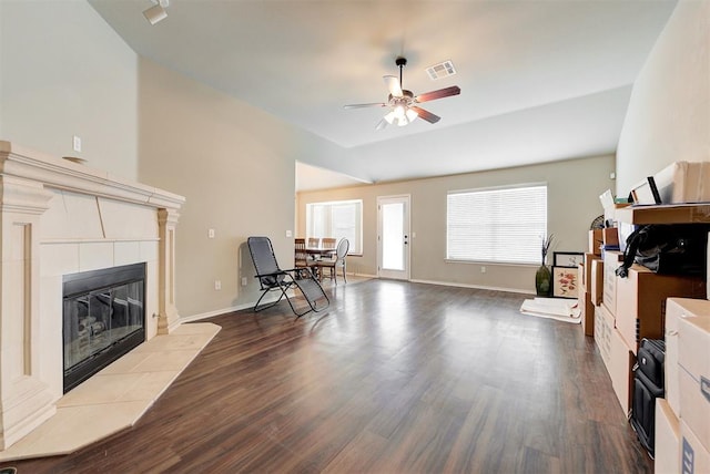 12032 SW 10th St, Yukon, OK 73099 - living room with ceiling fan, dark wood finished floors, a tile fireplace, and vaulted ceiling