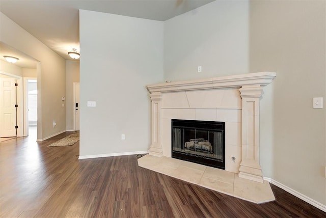 12032 SW 10th St, Yukon, OK 73099 - unfurnished living room featuring wood finished floors and a tile fireplace