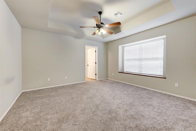 12032 SW 10th St, Yukon, OK 73099 - carpeted empty room featuring a tray ceiling and a ceiling fan