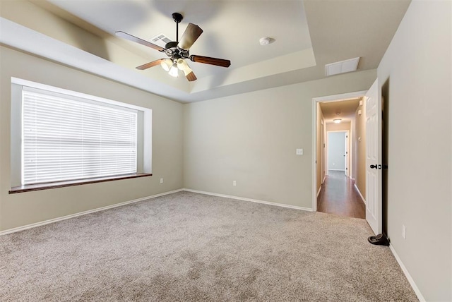 12032 SW 10th St, Yukon, OK 73099 - unfurnished room with carpet floors, a raised ceiling, ceiling fan, and a smoke detector