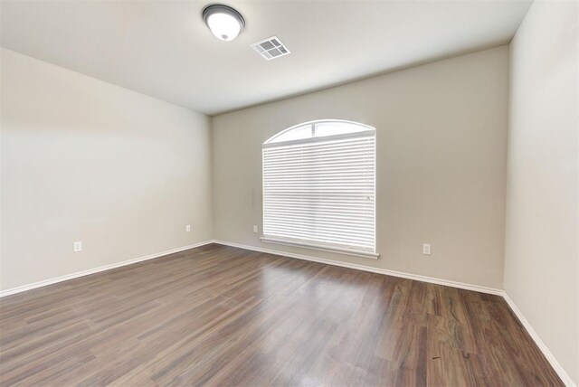 12032 SW 10th St, Yukon, OK 73099 - unfurnished room featuring dark wood-style floors and baseboards