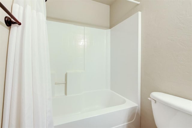 12032 SW 10th St, Yukon, OK 73099 - full bathroom with shower / bath combo with shower curtain and a textured wall