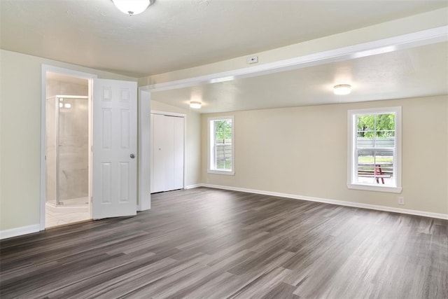 436 SE 54th St, Oklahoma City, OK 73129 - unfurnished bedroom featuring dark wood-type flooring, baseboards, ensuite bath, and a closet