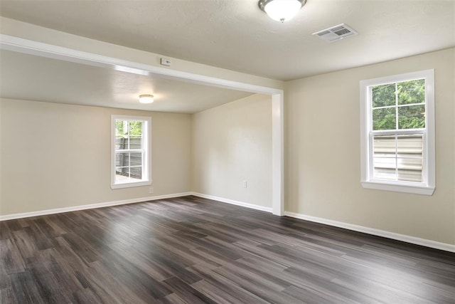 436 SE 54th St, Oklahoma City, OK 73129 - empty room featuring dark wood-style floors, healthy amount of natural light, and baseboards