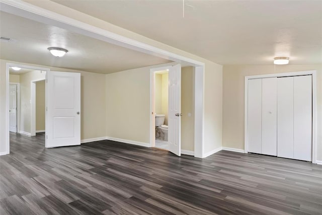 436 SE 54th St, Oklahoma City, OK 73129 - unfurnished bedroom with dark wood-style floors, baseboards, a closet, and ensuite bathroom