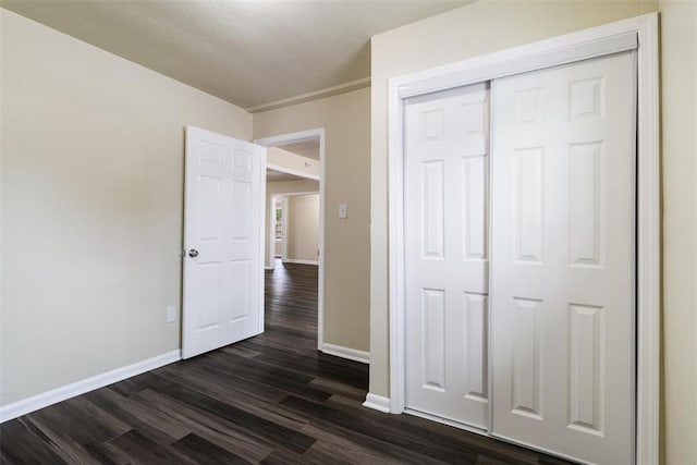 436 SE 54th St, Oklahoma City, OK 73129 - unfurnished bedroom with dark wood-style flooring, baseboards, and a closet