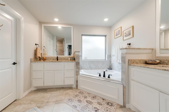 8208 Poplar Dr, Edmond, OK 73034 - full bath featuring two vanities, a garden tub, marble finish floors, and recessed lighting