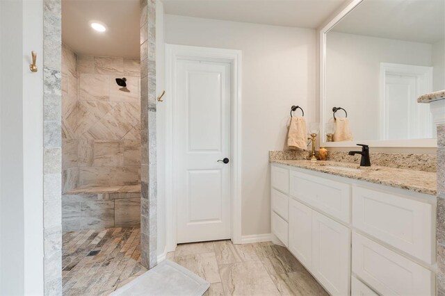 8208 Poplar Dr, Edmond, OK 73034 - full bathroom featuring vanity, tiled shower, and baseboards