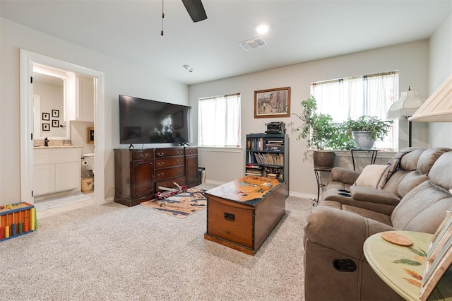 8208 Poplar Dr, Edmond, OK 73034 - living area featuring light carpet, ceiling fan, and baseboards